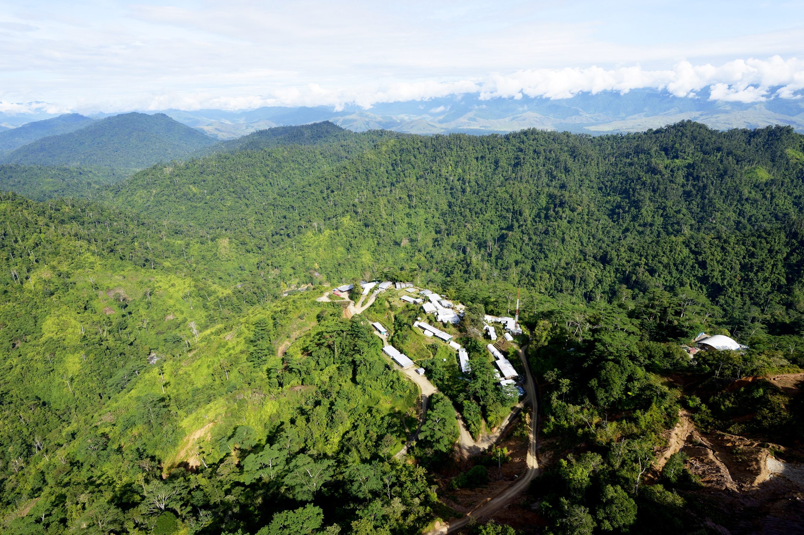 Wafi camp among forested hills in Morobe Province