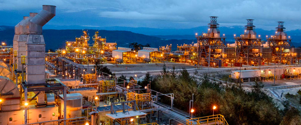 A gas processing plant lit up at dusk