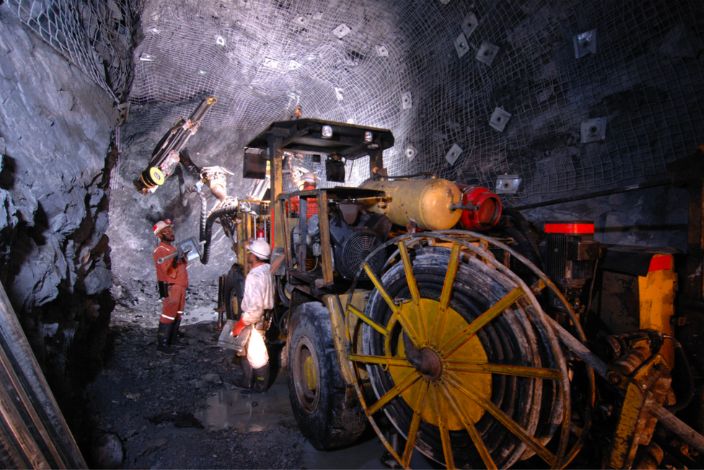 Miners with underground drilling equipment