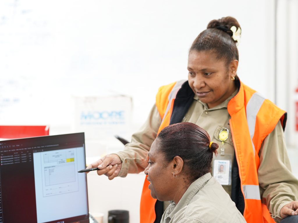 KutMor Human Resources officers, Isoul (front) and Jacinta at work at the Kutubu Site. (Photo credit: KutMor Ltd).