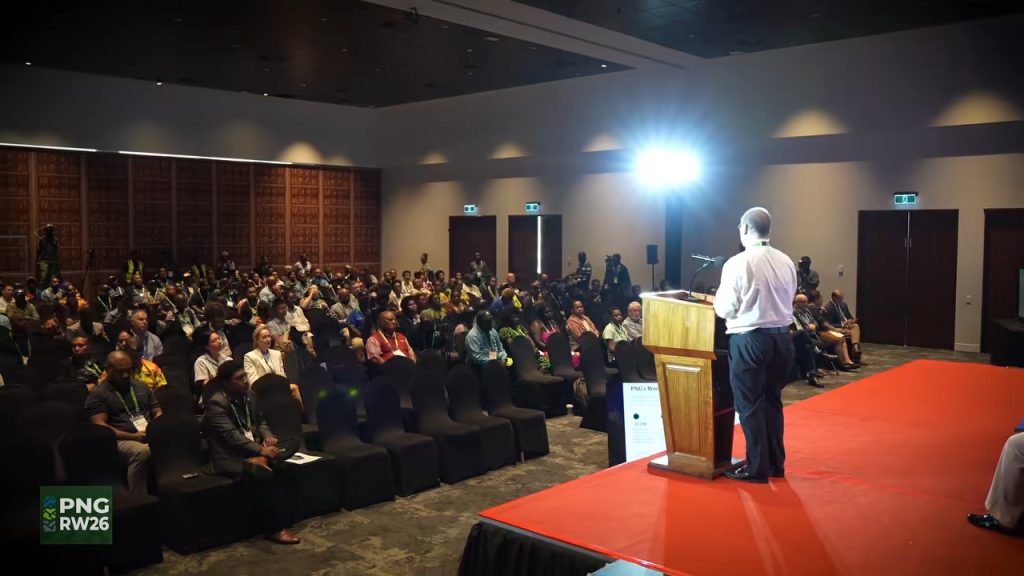 A speaker addresses seated delegates at PNG Resources Week 2026